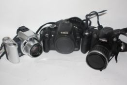 Canon 350 D body together with a Fujifilm S5200 and a Minolta Dimage