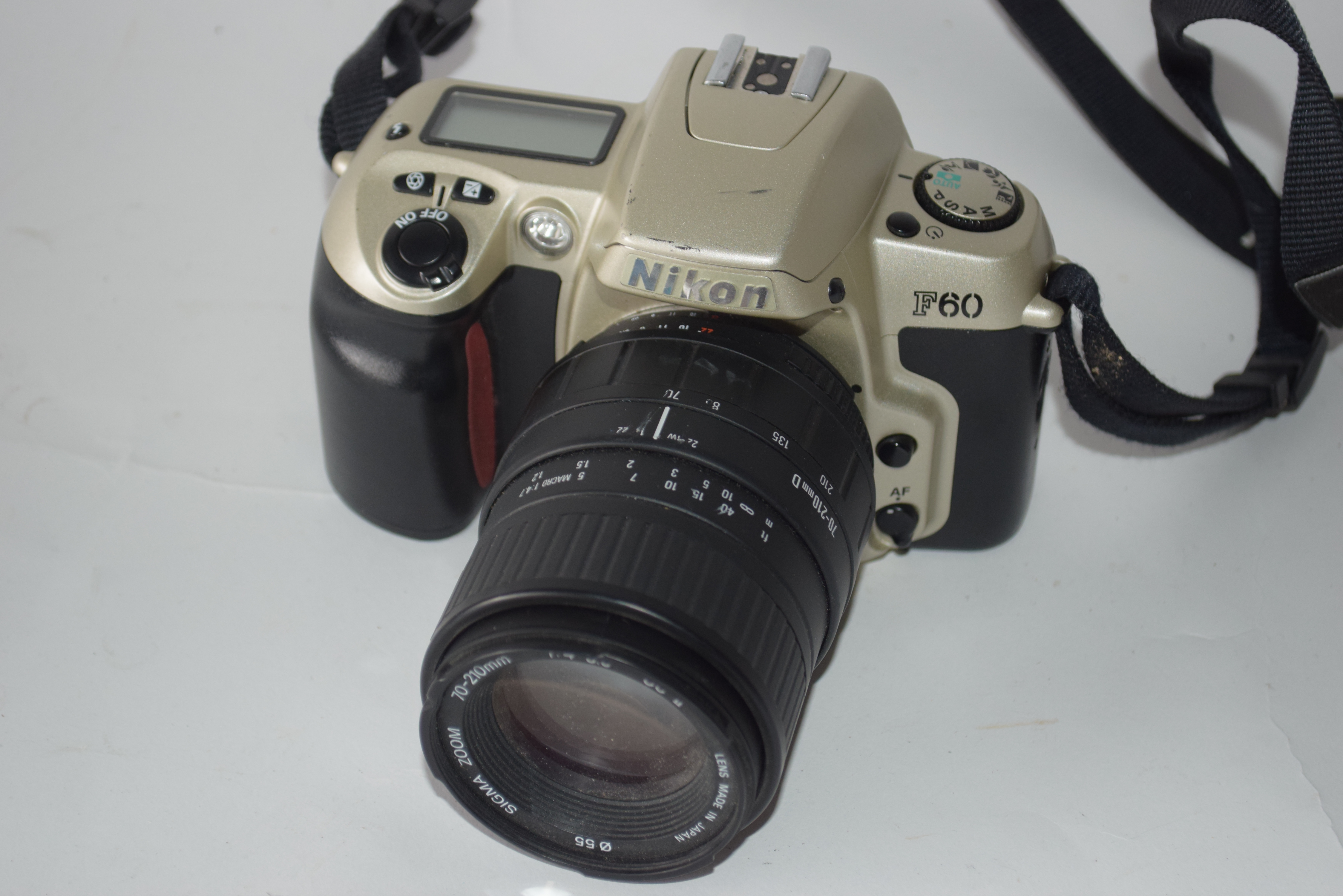 Nikon F60 film camera together with Sigma zoom 70-210mm lens, Nikon AF Nikkor 28-80mm lens and