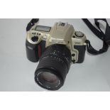 Nikon F60 film camera together with Sigma zoom 70-210mm lens, Nikon AF Nikkor 28-80mm lens and