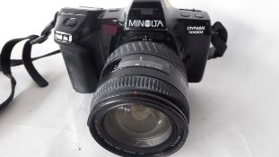 Minolta Dynax 7000i film camera together with a Minolta AF zoom 28-105mm lens