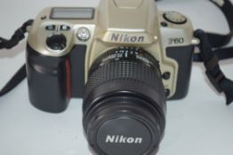 Nikon F60 film camera with film loaded, together with a Nikon AF Nikkor 35-80mm lens, manual and