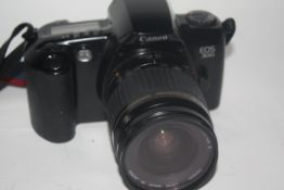 Canon EOS 500 film camera together with Canon zoom lens EF28-80mm