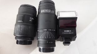 Sigma Zoom AF-APO 75-300mm lens together with a Sigma 70-300mm lens and a Minolta flash