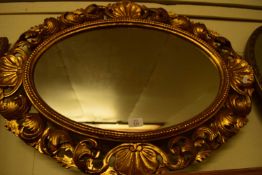 20TH CENTURY OVAL WALL MIRROR IN A PIERCED FOLIATE AND SHELL MOULDED FRAME, 77CM WIDE