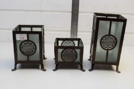 FOUR MODERN METAL FRAMED CHINESE CANDLE HOLDERS