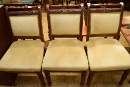 SET OF THREE LATE VICTORIAN DINING CHAIRS, THE FRAMED CARVED WITH OAK LEAF AND ACORN DETAIL