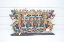 SOUTH EAST ASIAN PAINTED WALL PLAQUE MODELLED AS FIGURES ON A DRAGON BOAT