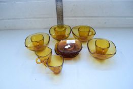 AMBER GLASS COFFEE CUPS AND SAUCERS AND RELATED BOWLS