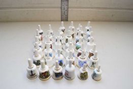 COLLECTION OF MINIATURE PORCELAIN BELLS CRESTED WITH VARIOUS TOWNS AND ROYALTY INTEREST