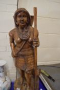 20TH CENTURY CARVED HARDWOOD FIGURE WITH DOG RAISED ON A PLINTH BASE, 90CM HIGH