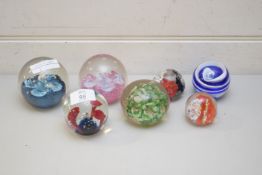 SIX VARIOUS COLOURED PAPERWEIGHTS