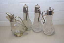 THREE CLARET JUGS WITH SILVER PLATED MOUNTS TOGETHER WITH A FURTHER CLARET JUG IN THE STYLISED
