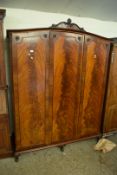 20TH CENTURY FLAME MAHOGANY VENEERED THREE DOOR WARDROBE WITH ARCHED TOP AND CARVED PEDIMENT,