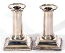 Pair of Victorian silver desk or dwarf candlesticks on square bases, with beaded edges, the plain