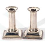 Pair of Victorian silver desk or dwarf candlesticks on square bases, with beaded edges, the plain