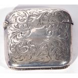 George V silver vesta case of hinged rectangular form decorated with foliate engraving, Birmingham