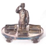 Unusual Victorian silver plated desk stand mounted with a figure of a shoeshine boy set on an oval