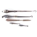Mixed Lot comprising two silver mounted glove hooks and two silver mounted boot hooks plus a further