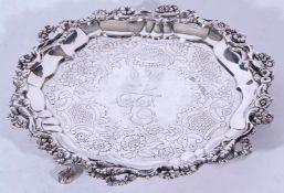 George IV silver waiter tray with floral border and engraved centre set on three swept legs with paw