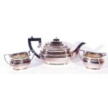 Queen Elizabeth II silver three piece tea service comprising tea pot with hinged lid and ebonised