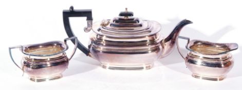 Queen Elizabeth II silver three piece tea service comprising tea pot with hinged lid and ebonised