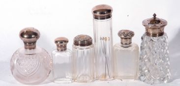 Collection of five various cut clear glass dressing table jars and a sugar sifter with silver