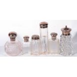 Collection of five various cut clear glass dressing table jars and a sugar sifter with silver