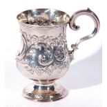 A small Victorian silver tankard with scrolled handle, baluster body decorated with sinuous floral