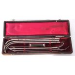 Medical interest - a group of seven various white and base metal catheters in a red fabric lined