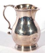 George III silver sparrowbeak cream jug, the baluster body with a scrolled handle over a ribbed