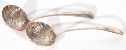 Pair of antique silver ladles of Old English pattern with large round shell bowls, bright cut