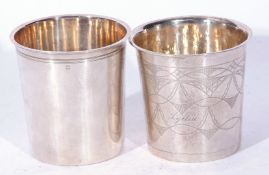 Two Continental white metal beakers of tapering cylindrical form, one with stylised decoration and