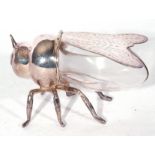 An unusual silver plate and clear glass desk tidy box formed as a fly, the hinged wings opening to