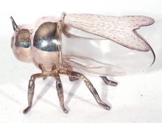 An unusual silver plate and clear glass desk tidy box formed as a fly, the hinged wings opening to