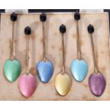 Set of six George V silver and enamel bean end coffee spoons set in a fitted case, Birmingham