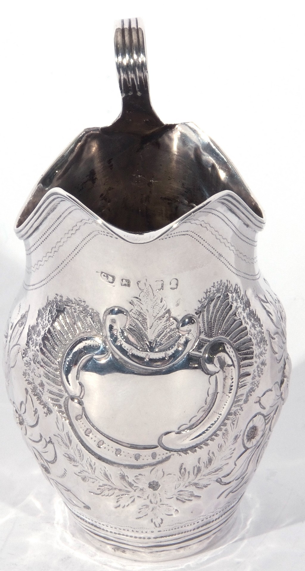 George III silver helmet formed cream jug with looped handle, the body with later floral - Image 3 of 4