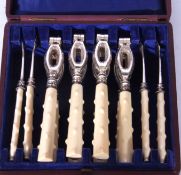 An unusual cased set of four silver plated and ivory handled lobster or crab crackers and