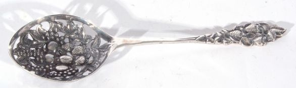 Dutch 835 grade silver/white metal straining spoon, decorated with a pierced design of fruit and