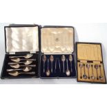 Mixed Lot: comprising a set of six silver apostle topped tea spoons and accompanying sugar tongs set