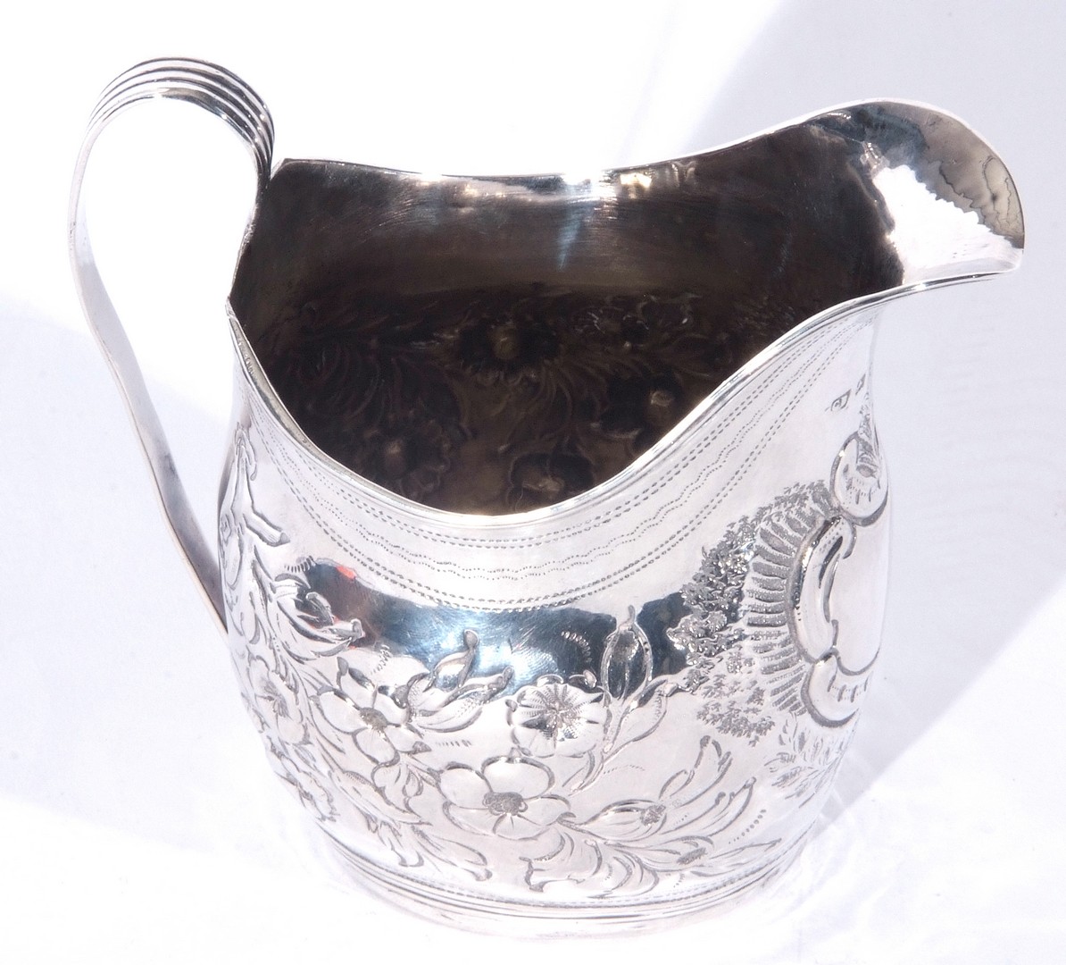 George III silver helmet formed cream jug with looped handle, the body with later floral - Image 2 of 4