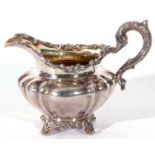 William IV silver cream jug of rounded and shaped design, gilt interior, having an acanthus capped