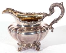 William IV silver cream jug of rounded and shaped design, gilt interior, having an acanthus capped