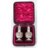 Pair of late Victorian silver pepper pots of baluster form, London 1892, makers Horace Woodward & Co