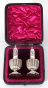 Pair of late Victorian silver pepper pots of baluster form, London 1892, makers Horace Woodward & Co