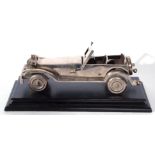 Cast metal model of a open topped vintage sports car set on an ebonised plinth base, the base 35cm