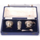 Queen Elizabeth II silver three piece cruet set comprising a cylindrical pepper pot, a mustard