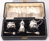 George VI silver condiment set comprising mustard with hinged lid and blue glass liner and three