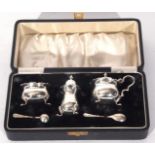 George VI silver condiment set comprising mustard with hinged lid and blue glass liner and three