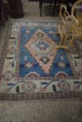 LARGE 20TH CENTURY WOOL FLOOR RUG WITH CENTRAL LOZENGE ON A BLUE AND PALE BACKGROUND, 261CM WIDE