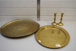 MIXED LOT COMPRISING TWO ISLAMIC BRASS TRAYS AND A PAIR OF CANDLESTICKS (4)